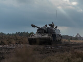 PZH2000NL artillery with crew positioned in field under cloudy conditions