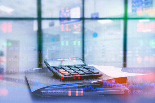 Calculator on a financial documents with overlay cryptocurrency charts and stock market data in office environment. Concept of finance, accounting, investment analysis and digital economy. - Powered by Adobe