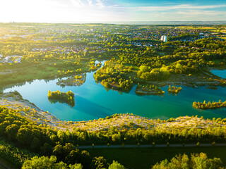 Aerial drone view of Dyckerhoffsee in Beckum, Germany, showing turquoise quarry lake surrounded by landscape and adjacent town in the M&uuml;nsterland region