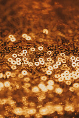 Shimmering gold texture.Bronze Sequined Fabric. Close-Up of Gold Sequins Fabric Texture. Close-Up of Gold Sequin Fabric. sequins wallpaper in a black and gold tones