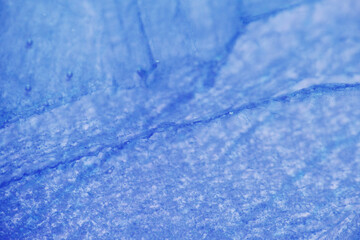 Macro shot captures the delicate textures of ice crystals forming across a frozen lake
