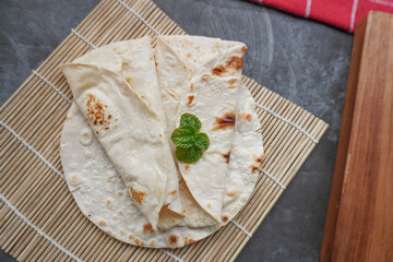 Flour Tortilla Wraps Homemade wheat tortillas, pita bread, tortilla, pita with ingredients for cooking on table. Top view. The concept of homemade food.