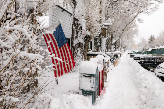 snow covered street and american flag  in Jackson Hole, Wyoming
