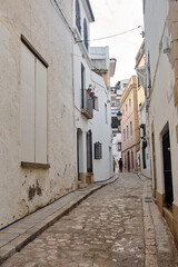 Obraz premium Narrow cobblestone street with traditional houses in Sitges, Spain