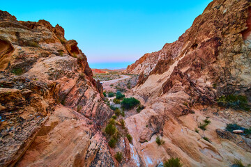 Fototapeta premium Desert Canyon Rocks and Winding Road under Clear Blue Sky