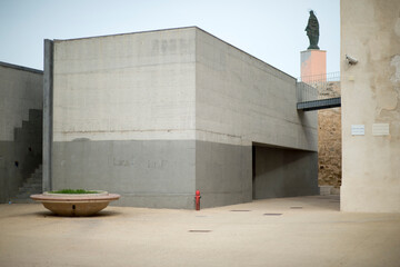 Fototapeta premium modern building in the city near University in Alghero, on top Madonna of Stella Maris on the tower of Sant Elmo, Sardinia, Italy