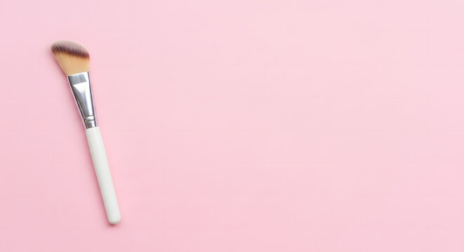 Professional makeup brush on a pink background
