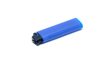 A blue plastic gas lighter lying on a white background, showing the ignition wheel and black head, symbolizing flame, fire, energy, and everyday practical use.