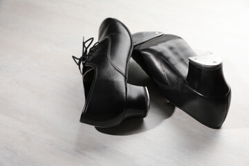 Pair of shoes for tap dance on white wooden floor, closeup