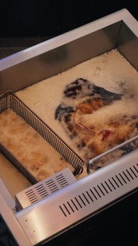 vertical 4k overhead video snapper fish frying in deep fryer professional kitchen part 1