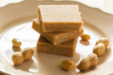 A stack of Paçoca and Raw Peanuts: A Traditional Brazilian Peanut Candy