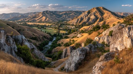 Fototapeta premium Panoramic view of a sunlit valley, river, and rocky hillsides