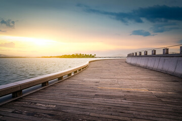 Fototapeta premium Scenic Wooden Pier Over Calm Water at Sunset