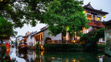 Obraz premium Traditional Chinese Houses Along Calm Water Canal