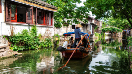 Fototapeta premium Traditional Chinese Boat Tour on Narrow Water Canal