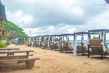 This serene beachfront area features cabanas along the sandy shore, perfect for relaxation in Cartagena, Colombia's Rosario Islands.