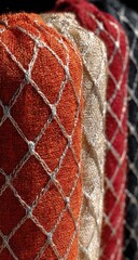 Close-up of folded fabrics with a diamond-patterned net