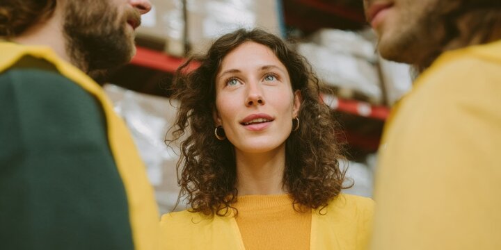 Professional Supply Chain Team Meeting in Warehouse Modern Authentic Collaboration and Strategic Business Planning for Corporate Marketing and Social Media - Powered by Adobe