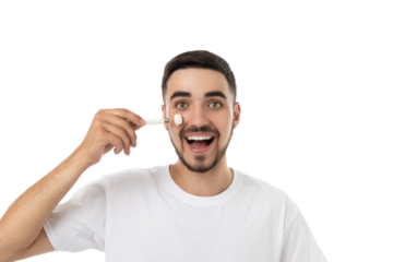 Man happily applying a facial roller on his skin, isolated, PNG