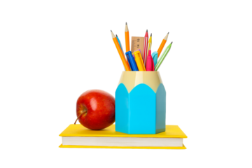 Colored pencils, an apple on stacked books, isolated on white, PNG