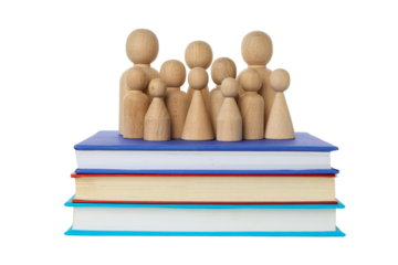 Wooden figures of students on books, isolated on white, PNG