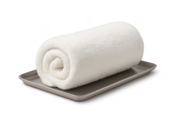 Rolled white towel resting on a tray with transparent background