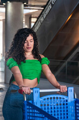 Adult woman pushing supermarket cart in parking lot