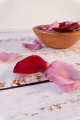 Close-up of a table with a container with some red and pink petals