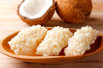 Brazilian white cocada, coconut candy, a traditional homemade treat very common in Brazil in the wooden bowl