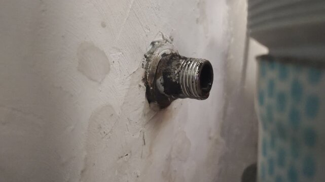 The threaded connection on the old, rusty, and damaged water pipe caused water to leak out. - Powered by Adobe