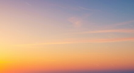 Sky gradient blending from yellow to blue with pink cloud streaks near horizon on tranquil day