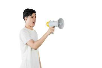 Man using a megaphone to announce something. A young man shouting into a megaphone, with a serious expression on his face, isolated on a white background.