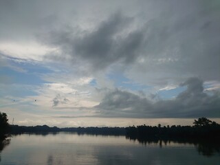 The Serene And Tranquil Waters Of A River On A Cloudy Day

