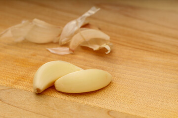 Closeup of Garlic Cloves on Wooden Cutting Board