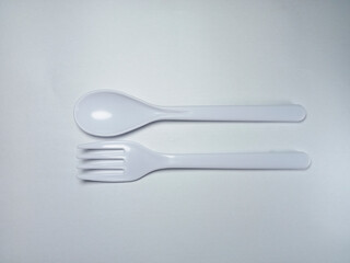 White plastic spoon and fork isolated on white background, as product catalog design profile for kitchen set, kitchen equipment and food