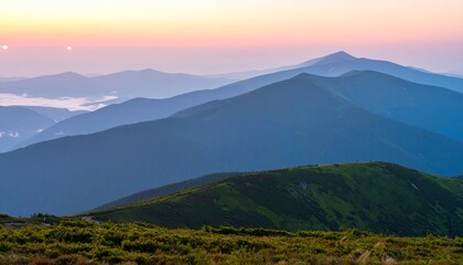 Fototapeta premium Mountain landscape with a misty forest and a golden sunrise casting a warm glow over the peaks and valleys