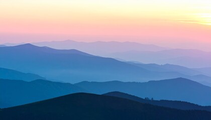 Fototapeta premium Mountain landscape with a misty forest and a golden sunrise casting a warm glow over the peaks and valleys