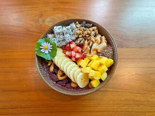 Acai bowl is a Brazilian-inspired dish made from pureed, frozen acai palm fruit, typically served in a bowl as a smoothie and topped with various ingredients. 