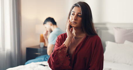 Woman, thinking or bed with regret for divorce, toxic relationship or domestic violence in home. Upset, female person or man with bedroom dispute for separation, conflict or confrontation in house