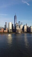 Obraz premium New York City skyline with skyscrapers reflecting on water
