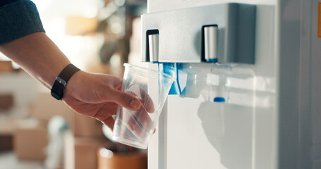 Hand, cup and water dispenser in office for health, wellness and hydration at ecommerce company....
