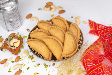 Gujhiya, Indian fried sweet with dry fruits and fancy decorative background