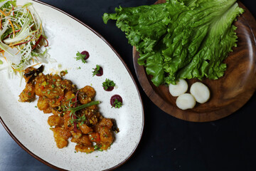 Crispy Water Chestnuts on white plate with lettuce on side