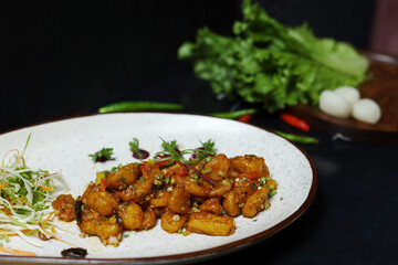 Crispy Water Chestnuts on white plate with lettuce on side