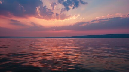 Fototapeta premium Sunset Reflection on a Calm Lake with Distant Hills