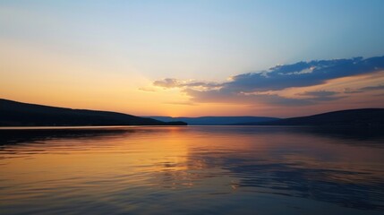 Fototapeta premium Sunset Reflection on a Calm Lake with Distant Hills
