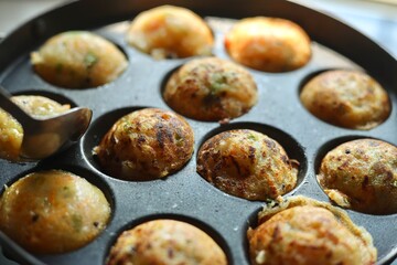 Appam or Mixed dal or Rava Appe South Indian dish preparation on iron pan