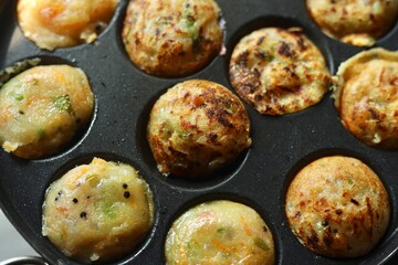 Appam or Mixed dal or Rava Appe South Indian dish preparation on iron pan