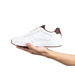  Transparent PNG available Hand holding white sneaker with brown details on transparent background