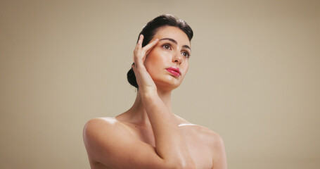 Obraz premium Woman, beauty and makeup with facial treatment for cosmetology on a studio background. Female person, model or thinking with cosmetics, dermatology or skincare for shine or skin glow on mockup space